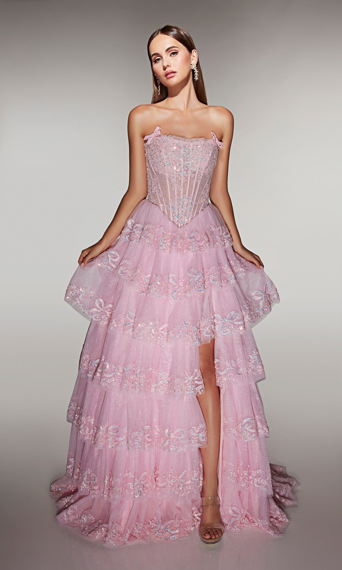 A woman stands facing forward against a neutral background wearing the Alyce 62191 long prom dress in rosewater, featuring a strapless embellished corset bodice and layered A-line skirt.
